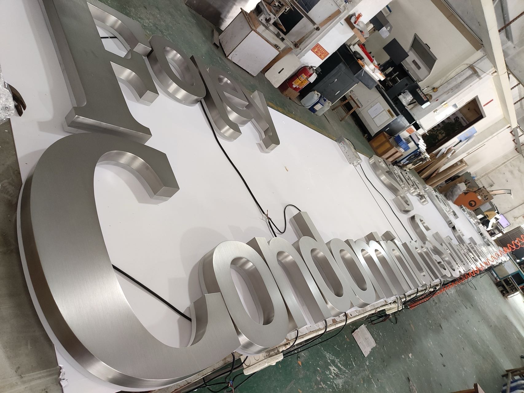 Large fabricated stainless steel halo-lit letters during production
